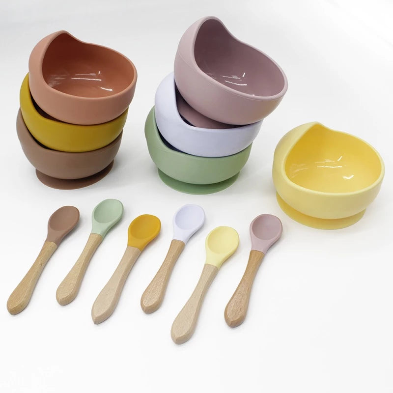 Silicone domed baby bowl set with wooden spoon for easy self-feeding, suction cup base sticks to the table without worrying about spilling