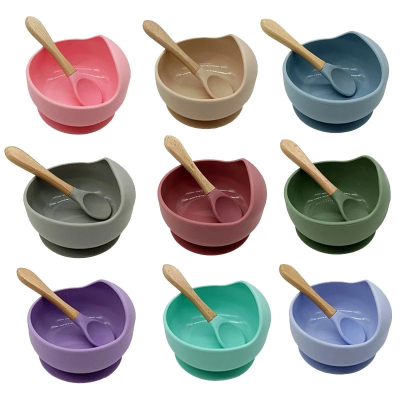 Silicone domed baby bowl set with wooden spoon for easy self-feeding, suction cup base sticks to the table without worrying about spilling